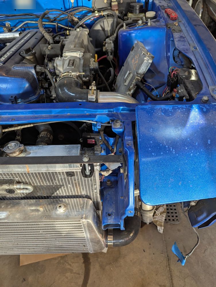 Throttle body, intake piping, and ECU in the Conquest engine bay